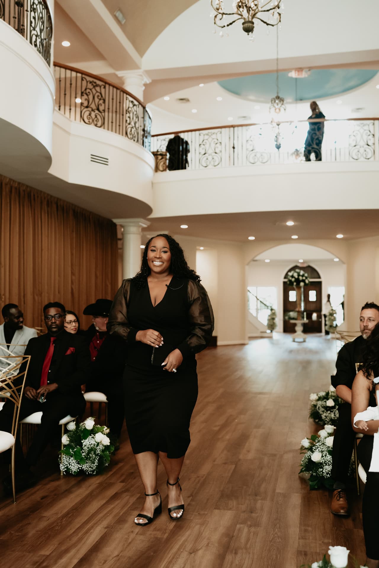 Jennifer Allen walking down the aisle to officiate a wedding ceremony